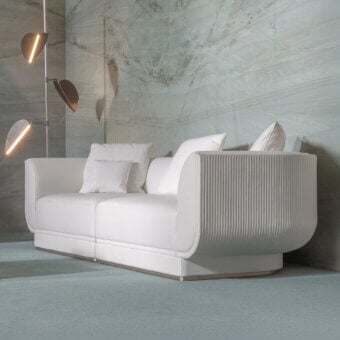 Superior Visionnaire Foster sofa with curved volumes and neutral beige upholstery exhibiting canneté quilting with a smooth matte finish
