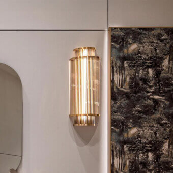 Distinguished Visionnaire Giano Wall Applique, a sculptural fixture crafted with satin steel and PVD gold borosilicate glass rods emitting ambient light