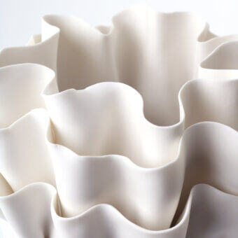 Distinguished FOS Ceramiche Fiordimar vase crafted in white biscuit porcelain with undulating layers and smooth matte finish