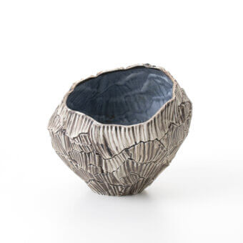 Superior FOS Ceramiche Zefiro Rock vase crafted in pure white porcelain with undulating ridges and bluish-gray interior hues