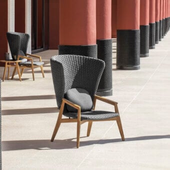 Exceptional Ethimo Knit lounge chair with a hand-finished teak frame and elegantly woven dark gray rope backrest