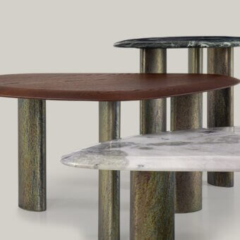 Distinguished Borzalino Egeo coffee table with uniquely shaped dark greenish-blue tabletop and subtly textured patinated metallic column