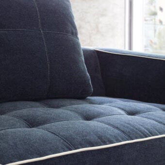 Refined CTS Salotti Clay sofa with dark blue-grey textile upholstery, quilted seat cushions and stained beech base crafting timeless comfort