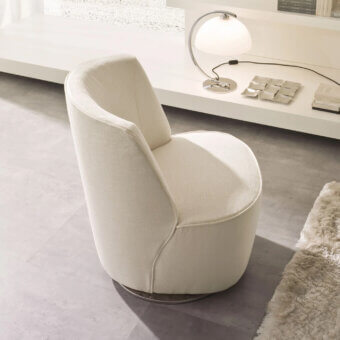 Distinguished CTS Salotti Cocoon lounge chair with softly contoured form and light beige subtly woven textile upholstery plus dark-toned metal swivel base