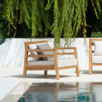 Distinguished Ethimo Costes lounge chair crafted with FSC-certified teak and light beige cushions in a worn pickled finish