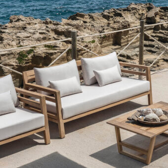 Exceptional Ethimo Costes sofa crafted with FSC-certified teak wood in a worn pickled finish with light beige cushions