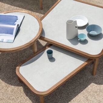 Distinguished Ethimo Grand Life coffee table with a light gray surface and warm wood frame built with a satin finish