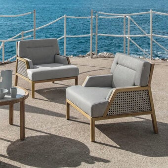 Elegant Ethimo Grand Life lounge chair with warm wood and light gray textile weave inspired by Vienna straw