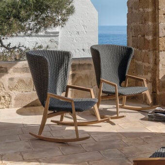 Captivating Ethimo Knit rocking lounge chair with FSC-certified teak and dark gray woven flat rope seat with a satin finish