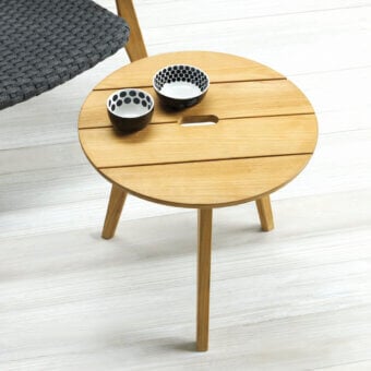 Distinguished Ethimo Knit side table in medium-brown teak wood with a smooth satin finish and subtle rectangular cutout