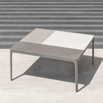 Distinguished Ethimo Play table with a two-tone grey and off-white composite tabletop and sleek metal frame in a matte finish