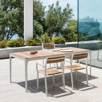 Distinguished Ethimo Play table crafted in warm-toned wood slats with a light-colored metal frame and smooth matte finish
