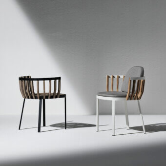 Exceptional Ethimo Swing armchair with black metal and teak slats, upholstered in smooth gray textile with a curved backrest
