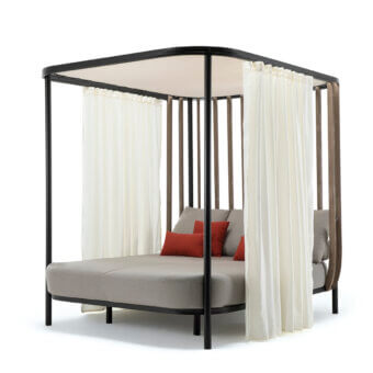 Captivating Ethimo Swing daybed crafted with matte black metal, warm teak wood, light gray cushions and reddish-orange pillows with sheer white curtains