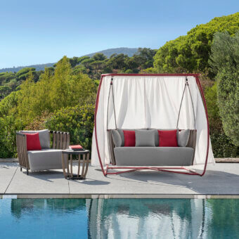 Captivating Ethimo Swing hanging sofa with a satin-finish red metal frame and rhythmic teak slats suspended by elegant ropes with gray cushions