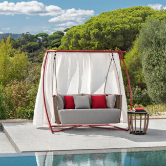 Superior Ethimo Swing hanging sofa with a reddish metal frame, teak slats, gray upholstery and flowing white textile panels