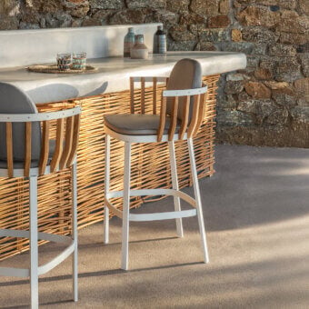 Exceptional Ethimo Swing stool crafted with teak slats, a white metal frame, and a woven natural tone backrest with a brown textile seat