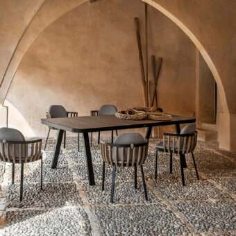 Sophisticated Ethimo Swing table with a dark gray aluminum structure and a teak slat tabletop in a matte finish
