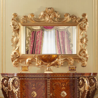 Distinguished Modenese Rubino Delight mirror crafted in gold tone with sweeping curves and abundant floral motifs