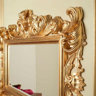 Lavish Modenese Rubino Delight mirror crafted in glossy gold with sculpted foliage and floral motifs
