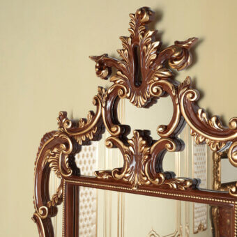 Exquisite Modenese Rubino Delight shaped mirror crafted in Italy with a glossy reddish-brown wooden frame and gilded accents