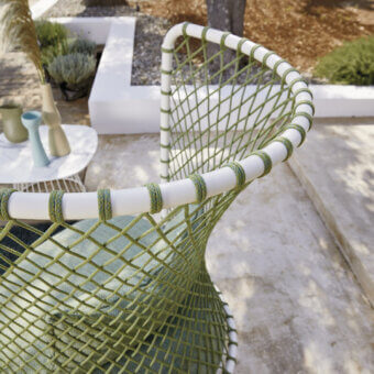 Distinctive Roberti Rattan Charme relax lounge chair with matte olive-green woven texture and white cord detailing in powder-coated steel