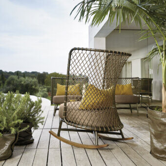 Superior Roberti Rattan Charme rocking lounge chair crafted with Flat Trendyrope, powder-coated steel, yellow cushions and light-toned wooden rockers