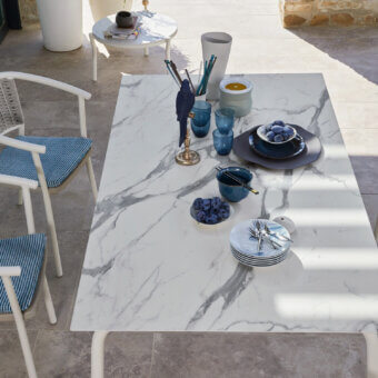 Elegant Roberti Rattan Lipari table with white marble-like HPL tabletop and grey veining in powder-coated stainless steel