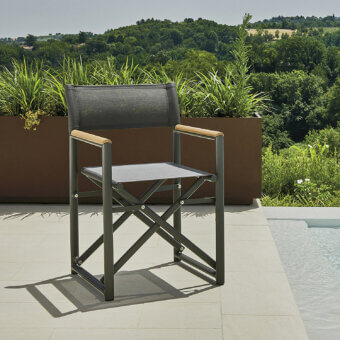 Distinctive Varaschin Victor armchair with muted gray quilted fabric, dark gray metal frame and refined teak wood armrests