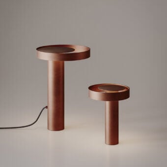 Superior VENICEM Circle Table Lamp with metal construction and burnished copper finish diffuses warm light in a cylindrical form
