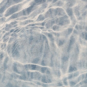 Exceptional Wall&Decò Reflex wallpaper presents a fluid abstract pattern in calming blue and beige tones with a water-based resin finish