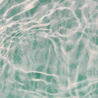 Superior Wall&Decò Reflex wallpaper showcases a wave-like pattern in grayish-green with swirling accents and a waterproof finish