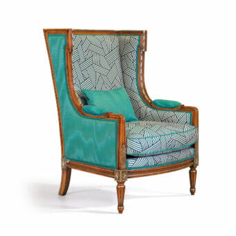 Superior Zanaboni Dorotea lounge chair crafted with golden-brown wood and teal, patterned blue and white fabric upholstery