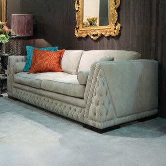Lavish Zanaboni Giada sofa with light grey-beige textile and captivating capitonné upholstery accented by vibrant cushions