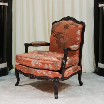 Distinguished Zanaboni Luigi XV lounge chair with terracotta upholstery and skilled wood carvings exhibiting a glossy finish