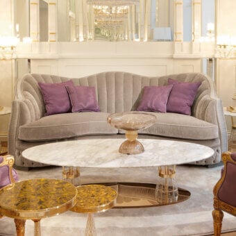 Superior Zanaboni Smeraldo sofa upholstered in textured matte fabric with soft lavender cushions and refined gold finish