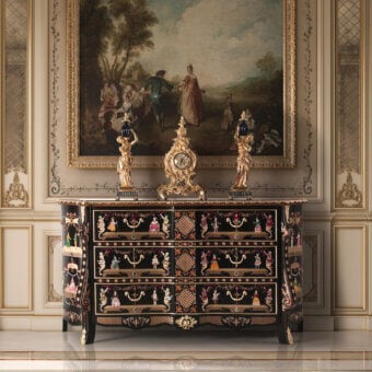 Distinguished Armando Rho A1296 dresser crafted in Italy with ebony finish, metal inlay and painted floral decorations with gilded accents