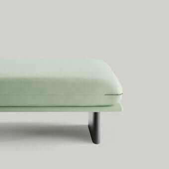 Distinguished Borzalino Connor ottoman with light green textile upholstery and sleek dark-toned wood sled base crafted in Italy