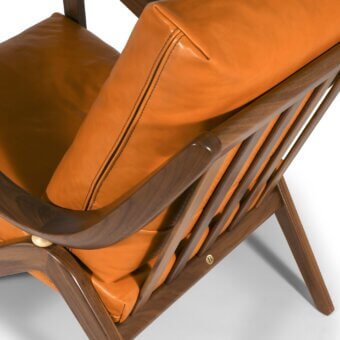 Distinguished Borzalino Taylor armchair with saturated orange-brown leather upholstery and hand-carved canaletto walnut frame