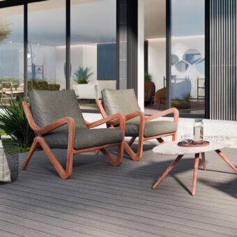 Distinctive Borzalino Taylor armchair with sinuous canaletto walnut frame in a natural finish and muted gray textile cushions