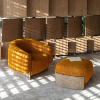 Distinctive Carpanese Home Betty lounge chair with golden-yellow bouclé textile and light-finished wood frame