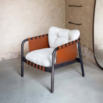 Distinguished Carpanese Home Bridge lounge chair crafted with solid beech wood and reddish-brown leather panels in a dark matte finish