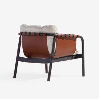 Exceptional Carpanese Home Bridge lounge chair with solid beech wood frame and reddish-brown handcrafted leather panels with light textile cushions