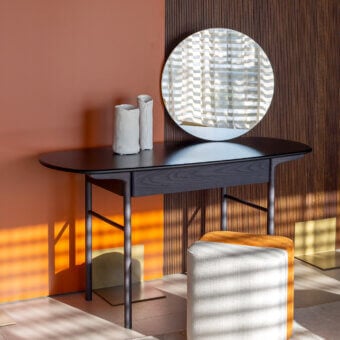 Elegant Carpanese Home Delorean vanity crafted with slender ash wood and glossy marble, featuring a natural circular mirror with matte dark gray finish