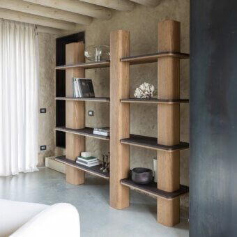 Distinguished Carpanese Home Erice L bookcase in solid ash wood with a satin finish exhibiting a tall asymmetrical form