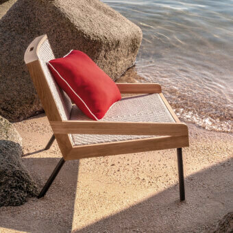 Distinguished Ethimo Allaperto lounge chair with red cushion and woven seat crafted in satin-finish wood