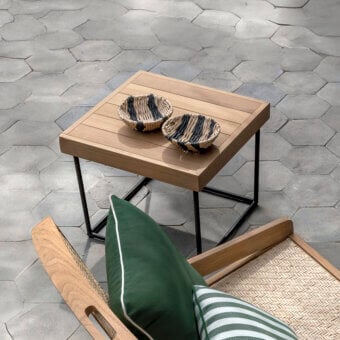 Distinguished Ethimo Allaperto coffee table with a warm medium-brown wood tabletop and sleek black metal base in satin finish