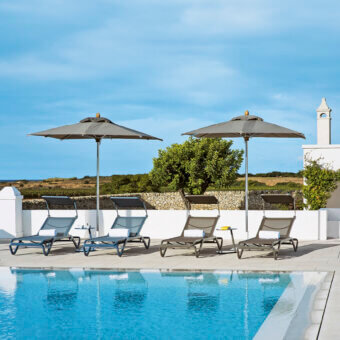 Elegant Ethimo Free Umbrella parasol in neutral gray textile with a satin metal pole