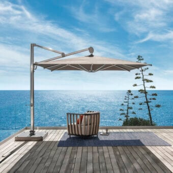 Superior Ethimo Freedom umbrella crafted in Italy with a neutral gray metal frame and light beige matte textile canopy
