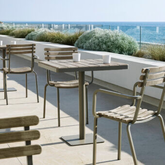 Distinguished Ethimo Laren Bistrot table crafted in Italy with gray-brown wood tabletop and satin-finish metal base